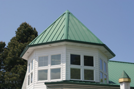White house with a green metal roof