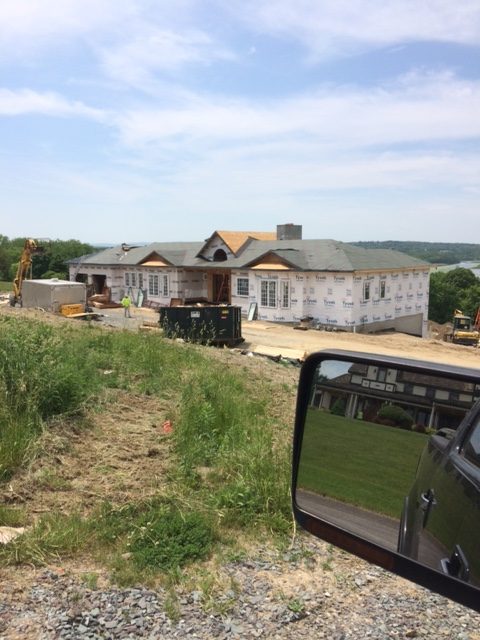 A large home being built on a sunny day