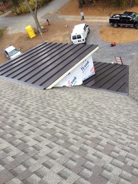 A roof with a combination of metal and asphalt shingles