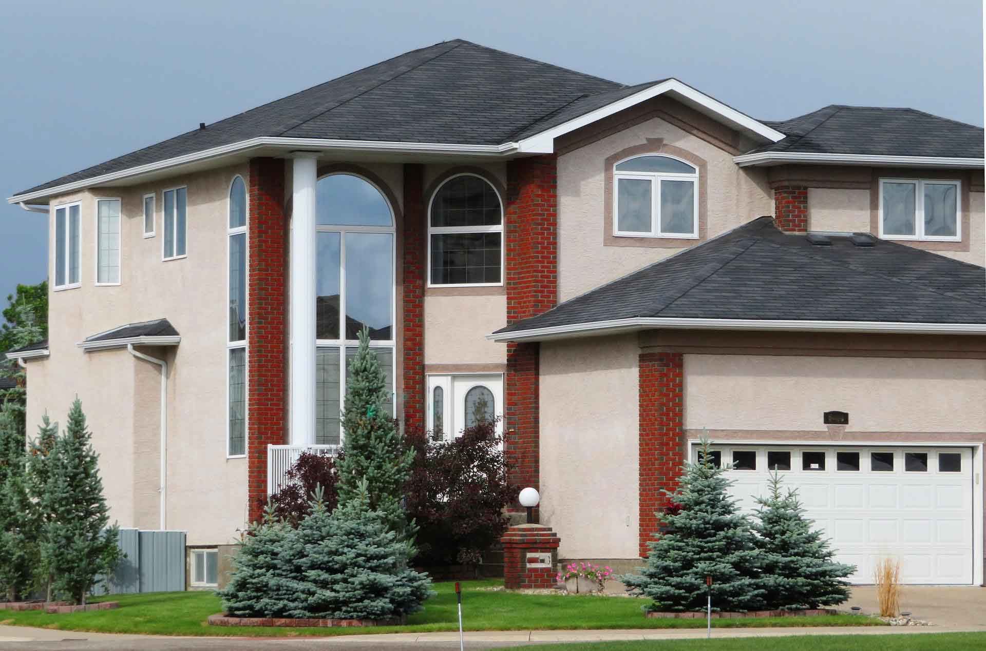 A large house with an asphalt shingle roof