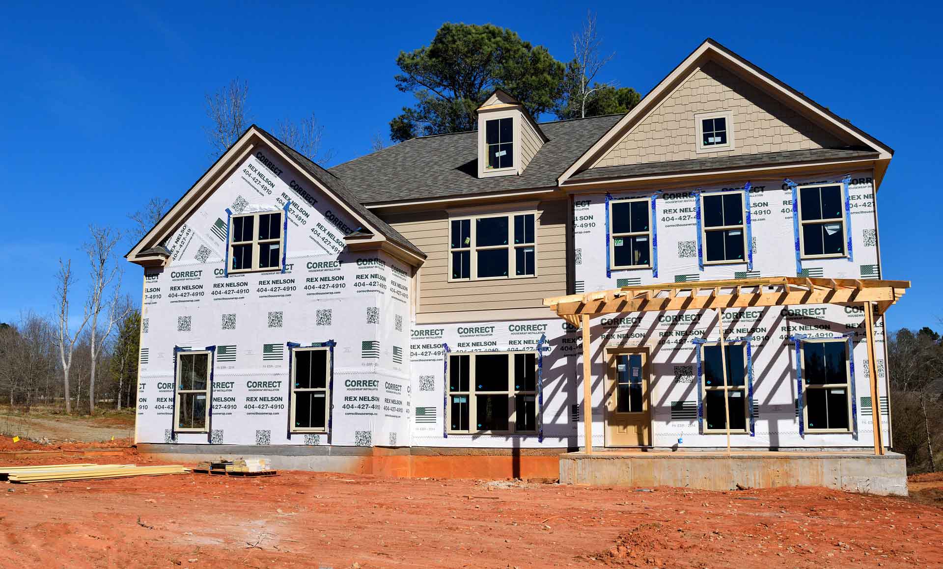 An under-construction house with a new shingled roof