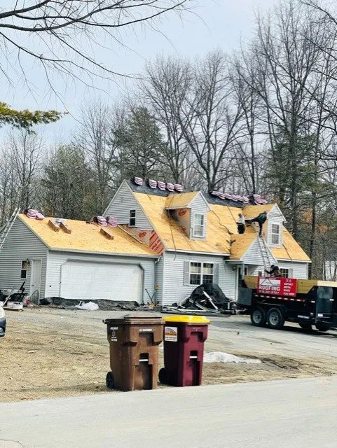 The roofing team from Allen Roofing, LLC installing a new roof on a house with attached garage